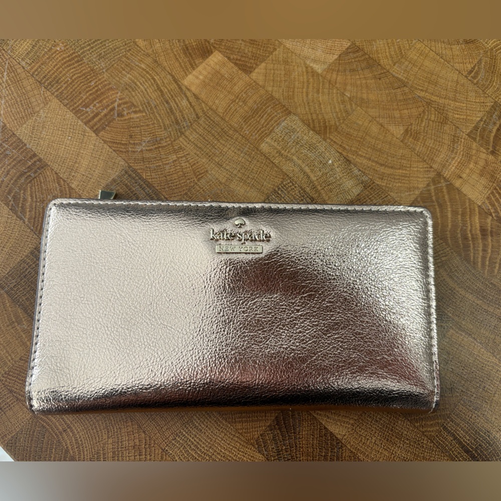 Kate Spade Rose Gold Bifold wallet with black and white interior accents